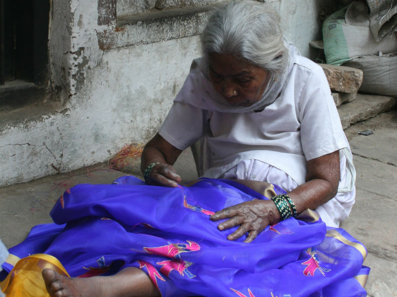 Old Lady Sewing a Garment